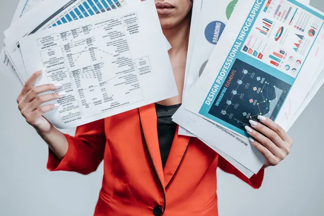A professional in orange attire holding various business documents and infographics. An invented accounting software migration: where the five weeks actually went