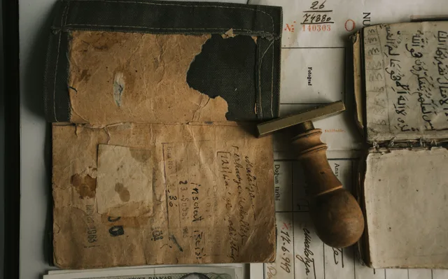 Top view of vintage documents and a wooden stamp, showcasing historical writing and paper textures. Accounts payable framework: who holds which payment gate